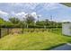 Fenced backyard with lush lawn and well-maintained landscaping at 1915 Terrapin Rd, Ocoee, FL 34761