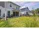 A home's backyard features well-maintained lawn, a patio, and sliding glass doors for indoor-outdoor living at 1915 Terrapin Rd, Ocoee, FL 34761