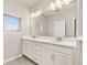 This light and bright bathroom boasts a double vanity, neutral paint, and silver hardware at 1915 Terrapin Rd, Ocoee, FL 34761