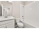 Clean bathroom with white vanity, framed mirror, and tiled shower-tub combination, offering a fresh and functional space at 1915 Terrapin Rd, Ocoee, FL 34761