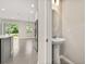 This half bath features a pedestal sink and is conveniently located near the kitchen and living area at 1915 Terrapin Rd, Ocoee, FL 34761