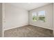 Neutral bedroom with plush carpet, two large windows providing lots of natural light, and freshly painted walls at 1915 Terrapin Rd, Ocoee, FL 34761