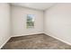Cozy bedroom with plush carpeting and a single window, providing a peaceful and comfortable personal retreat at 1915 Terrapin Rd, Ocoee, FL 34761