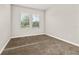 Bedroom with soft carpeting and abundant natural light from two windows, creating a cozy and inviting atmosphere at 1915 Terrapin Rd, Ocoee, FL 34761