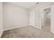 Comfortable bedroom with neutral carpet, offering serene space and featuring a doorway and closet for functionality at 1915 Terrapin Rd, Ocoee, FL 34761