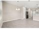 Open dining area features tile floors and easy access to the kitchen with modern stainless steel appliances at 1915 Terrapin Rd, Ocoee, FL 34761