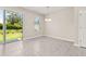 Dining area featuring tile floors, a chandelier, and sliding glass doors leading to the backyard at 1915 Terrapin Rd, Ocoee, FL 34761