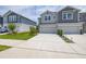 Wide concrete driveway leading to attached garages, with green lawns on either side at 1915 Terrapin Rd, Ocoee, FL 34761