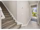 Inviting entryway featuring a staircase, tile flooring, and a view to the outside at 1915 Terrapin Rd, Ocoee, FL 34761