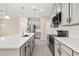 Open kitchen with gray cabinets, white countertops, stainless steel appliances and a large island at 1915 Terrapin Rd, Ocoee, FL 34761