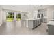 Modern kitchen with gray cabinets, a center island, and stainless steel appliances at 1915 Terrapin Rd, Ocoee, FL 34761