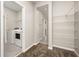 Convenient laundry room with washer, dryer and wire shelving at 1915 Terrapin Rd, Ocoee, FL 34761