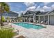 Community pool with lounge chairs and a covered area for relaxing by the pool at 1915 Terrapin Rd, Ocoee, FL 34761