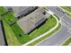 Aerial view of a modern home with a well-kept lawn, hardscaped driveway, and street at 2388 Volunteer Ave, Kissimmee, FL 34744