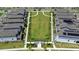 An aerial shot shows the central green space and a walkway lined with newly built residences at 2388 Volunteer Ave, Kissimmee, FL 34744