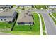 An aerial view shows the well-maintained lawn, street corner, and fenced in back patio at 2388 Volunteer Ave, Kissimmee, FL 34744