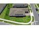 Aerial view of a modern home with a well-kept lawn, hardscaped driveway, and street at 2388 Volunteer Ave, Kissimmee, FL 34744
