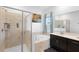 Elegant bathroom with a glass-enclosed shower, soaking tub, and a spacious vanity with double sinks at 2388 Volunteer Ave, Kissimmee, FL 34744