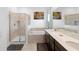 Inviting bathroom featuring a shower, bathtub, double sinks, and sleek vanity at 2388 Volunteer Ave, Kissimmee, FL 34744