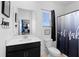 Modern bathroom with a black vanity, white countertop, toilet, and tiled shower at 2388 Volunteer Ave, Kissimmee, FL 34744