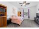 Bedroom with a single bed, dark wood dresser, and a window providing natural light at 2388 Volunteer Ave, Kissimmee, FL 34744