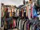 Walk-in closet with rods and shelves filled with an array of clothing and shoes for ample storage at 2388 Volunteer Ave, Kissimmee, FL 34744