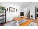 Stylish dining area featuring a wooden table, bench seating, modern decor and house plants at 2388 Volunteer Ave, Kissimmee, FL 34744