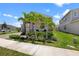 Eye-catching home with stone accents, complemented by lush landscaping and vibrant palm trees at 2388 Volunteer Ave, Kissimmee, FL 34744