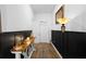 Beautiful hallway with wainscoting, wood-look tile flooring, and stylish console table decor at 2388 Volunteer Ave, Kissimmee, FL 34744