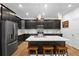 Modern kitchen boasts stainless steel appliances, sleek cabinets, a large island with seating at 2388 Volunteer Ave, Kissimmee, FL 34744