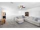 Open living area with sectional seating, bookshelves, and a view of the staircase at 2388 Volunteer Ave, Kissimmee, FL 34744