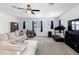 Open living room featuring a comfy sofa, bookshelves, desk, and a sleek treadmill at 2388 Volunteer Ave, Kissimmee, FL 34744
