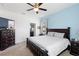 Spacious main bedroom featuring a dark wood dresser, nightstands, and a view into the bathroom at 2388 Volunteer Ave, Kissimmee, FL 34744