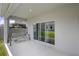 Covered patio with a hanging swing and sliding glass doors to the backyard at 2388 Volunteer Ave, Kissimmee, FL 34744