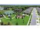 A high angle shot of a well-equipped community playground, tennis court, and manicured landscaping at 2388 Volunteer Ave, Kissimmee, FL 34744