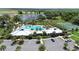 A high angle shot of a community pool, tennis court, parking lot, and lake in the background at 2388 Volunteer Ave, Kissimmee, FL 34744