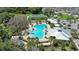 A high angle shot of a community pool with sun loungers, and a water slide at 2388 Volunteer Ave, Kissimmee, FL 34744