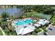 A high angle shot of a resort-style community pool, tennis court, and manicured landscaping at 2388 Volunteer Ave, Kissimmee, FL 34744