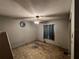 This bedroom features a ceiling fan and window with dark curtains at 2558 El Capitan Dr, Sanford, FL 32773