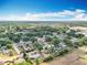 Expansive aerial view of a neighborhood with mature trees and clear blue skies at 2571 Edmond Cir, Auburndale, FL 33823