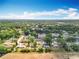 Scenic aerial view of a community with lush greenery and bright blue skies overhead at 2571 Edmond Cir, Auburndale, FL 33823