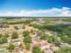Wide aerial shot of the area showcasing the neighborhood, the road, trees, lakes, and the horizon at 2571 Edmond Cir, Auburndale, FL 33823