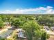 Overhead view showing a neighborhood with tree-lined streets and well-spaced homes under a sunny sky at 2571 Edmond Cir, Auburndale, FL 33823
