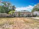Exterior of home featuring solar panels, landscaping with palm trees, and well-kept lawn at 2571 Edmond Cir, Auburndale, FL 33823