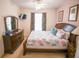 Comfortable bedroom with ceiling fan, dresser and bedside table with lamp at 2788 Almaton Loop # 202, Kissimmee, FL 34747
