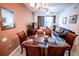 Elegant dining area with a glass table and seating for six, connected to the living space at 2788 Almaton Loop # 202, Kissimmee, FL 34747