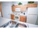 Well-lit kitchen featuring white appliances, light wood cabinets, and ample counter space at 2788 Almaton Loop # 202, Kissimmee, FL 34747