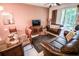 Comfortable living room with leather sofas, dining area, and natural light from sliding doors at 2788 Almaton Loop # 202, Kissimmee, FL 34747