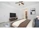 This staged bedroom features a ceiling fan, tile floors and a walk-in closet at 2807 Sw 161St Loop, Ocala, FL 34473