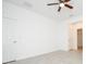 A bedroom with tile flooring, a ceiling fan and access to both closet and bathroom at 2807 Sw 161St Loop, Ocala, FL 34473
